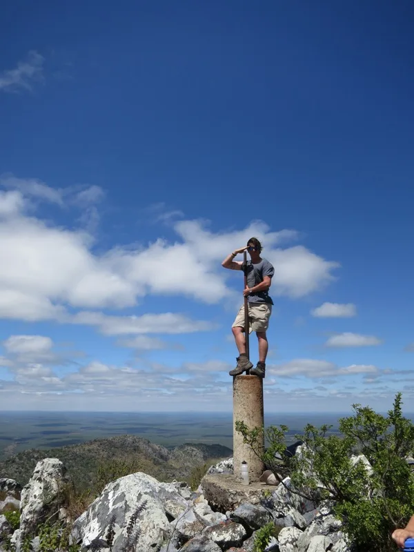 Standing atop the concrete pillar which marks the very top of Mt Lavushi and the highest point in the surrounding area (photograph by Jorden Wilson)!