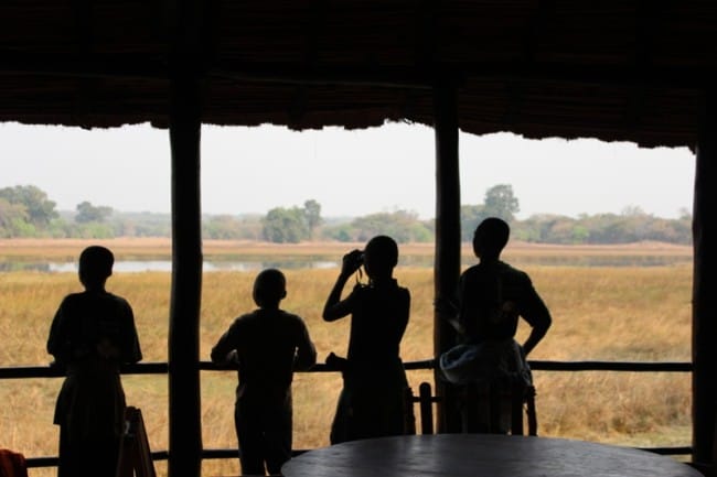 Local children admiring the Hippo's opposite Wasa Lodge in Kasanka National Park.